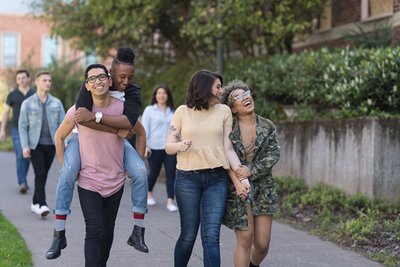 Group of diverse young people walking together, symbolizing inclusion and support