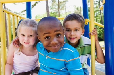 Children playing together on playground, illustrating social play