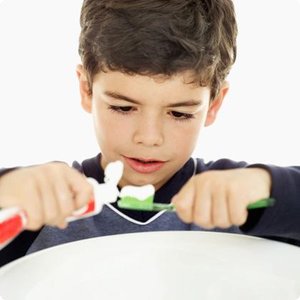 Child practicing brushing teeth, representing effortful control