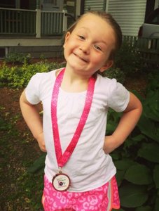 Child with medal, representing initiative and achievement