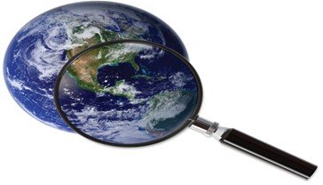 Magnifying glass over the Earth, symbolizing scientific investigation