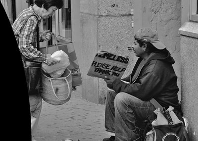 Person giving food to a homeless individual