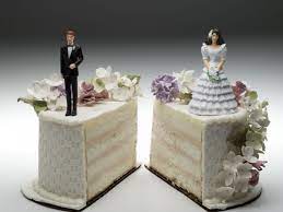 Wedding cake split in two with bride and groom figures on each side, symbolizing divorce