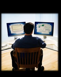 Person analyzing data on computer screens, representing cognitive processing