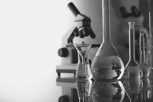 Laboratory glassware and microscope, representing scientific research
