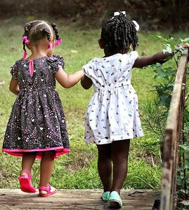 Two children walking together, illustrating friendship