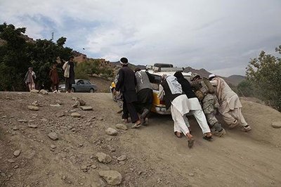 People working together to push a vehicle