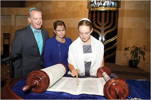 Bat mitzvah ceremony with Torah scrolls