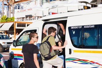 Commuters boarding a minibus taxi in South Africa