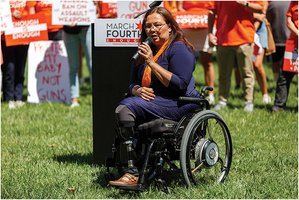 Senator Tammy Duckworth, a prominent advocate for disability rights, speaking at a rally