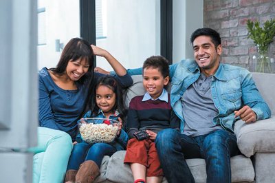 A family watching television together, representing a sample in a statistical study