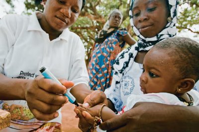 A healthcare worker administering a vaccine to a child, illustrating the application of statistics in public health